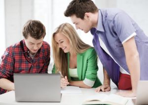students writing test or exam in lecture at school